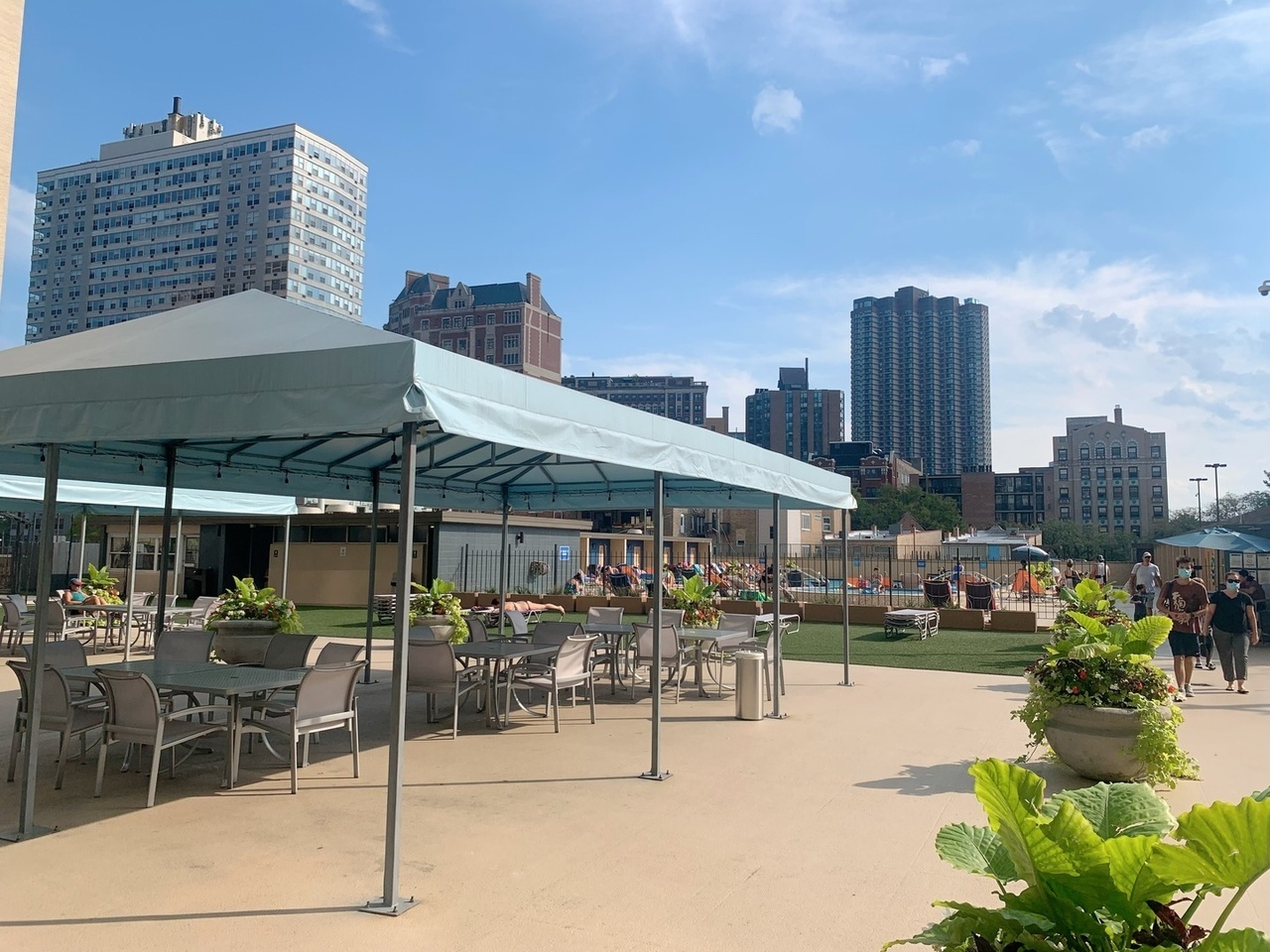 655 West Irving Park Road, Unit 1505 Chicago, IL 60613 - Photo 20 of 23 a view of a patio with a table and chairs and potted plants