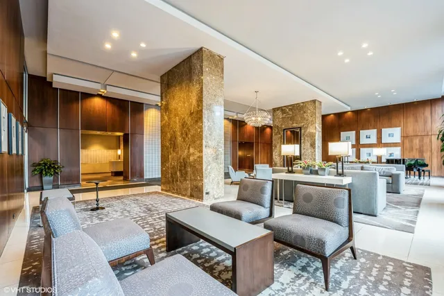 a view of a room with wooden floor and a bathroom