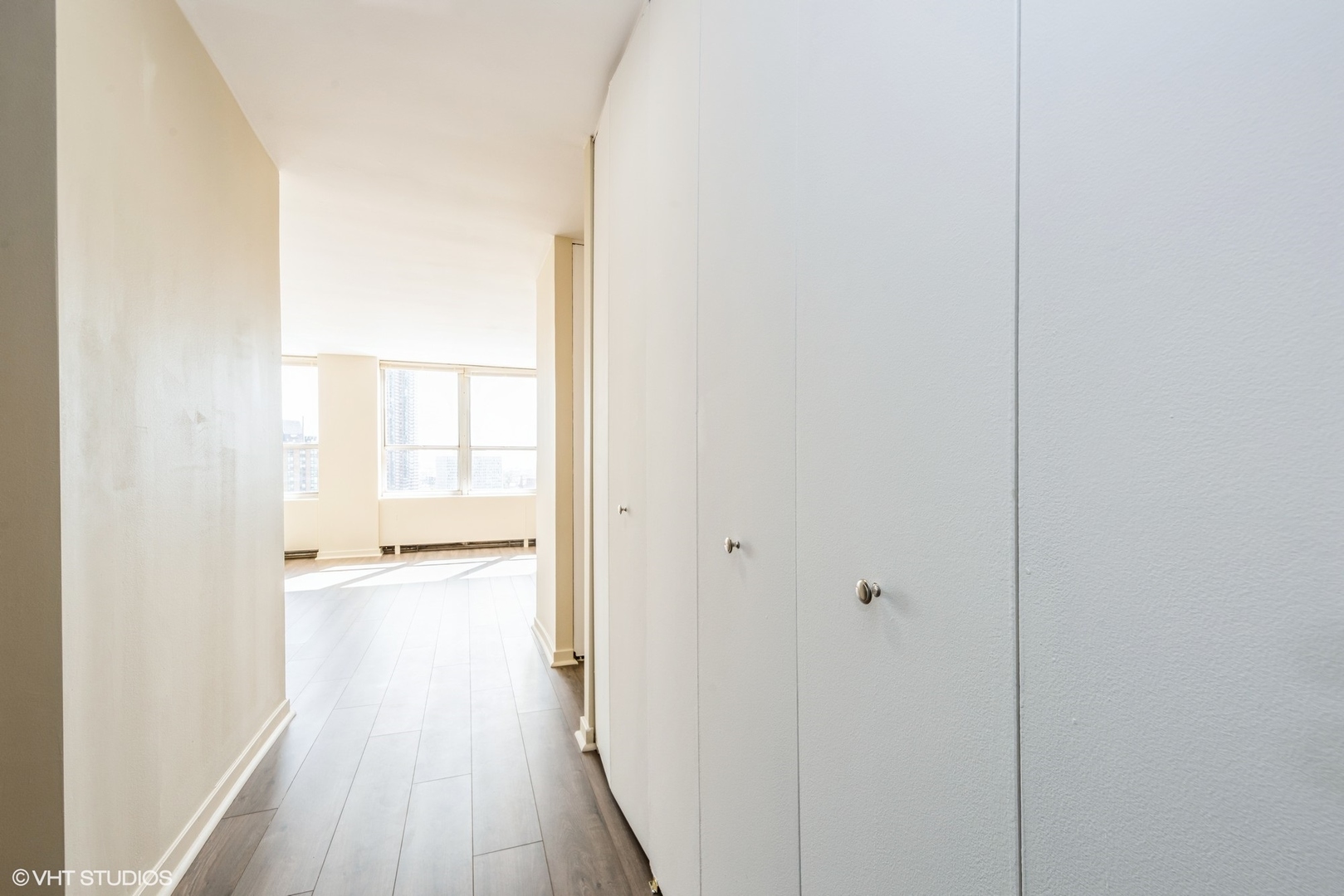 655 West Irving Park Road, Unit 1505 Chicago, IL 60613 - Photo 4 of 23 a view of a room with wooden floor and a bathroom