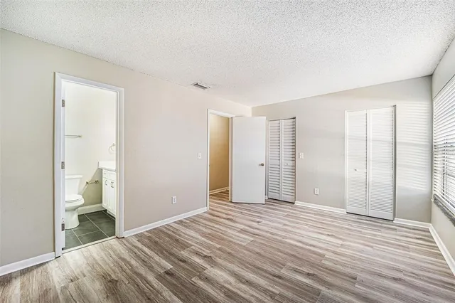 a view of a room with wooden floor and bathroom