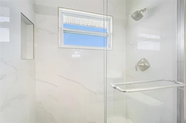 a bathroom with a glass shower door