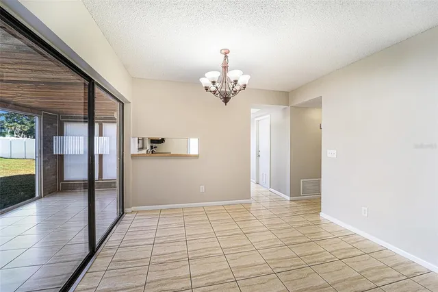 a view of a hallway with a chandelier