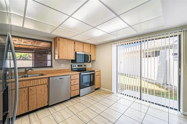 a kitchen with stainless steel appliances granite countertop a stove sink and cabinets