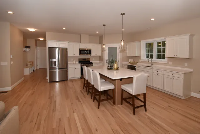 a large kitchen with a table and chairs