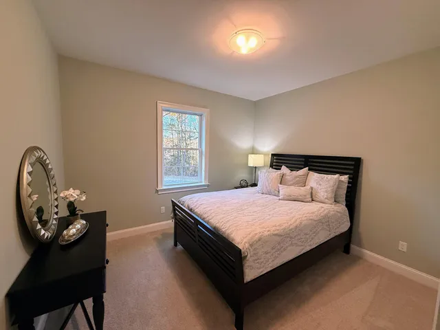 a bedroom with a bed and a chair