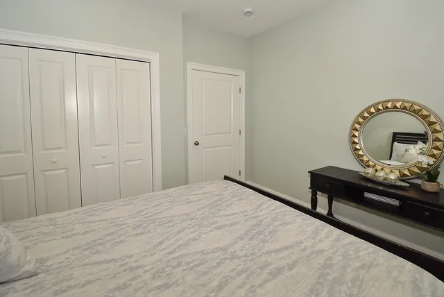a bedroom with a bed and a dresser