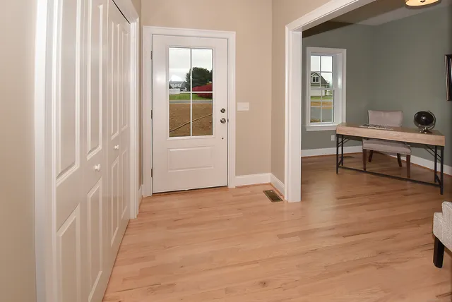 a view of a room with wooden floor and windows