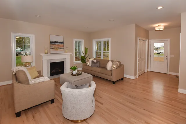 a living room with furniture and a fireplace