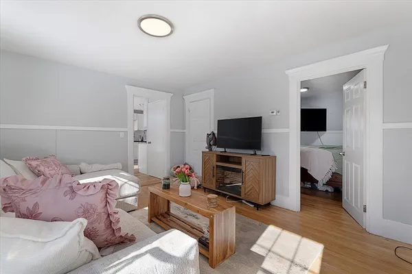 a bedroom with furniture and a flat screen tv