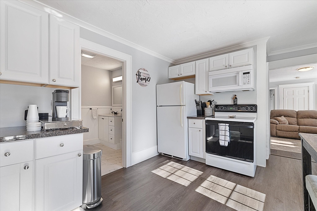 14 Central Street Ashburnham, MA 01430 - Photo 19 of 42 a kitchen with stainless steel appliances a refrigerator sink and cabinets