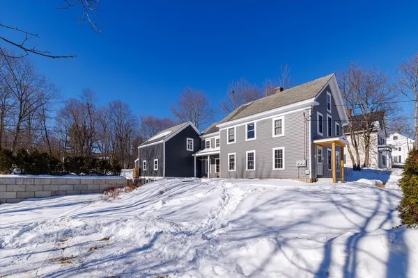 a view of a house with a snow in the yard
