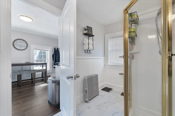 a view of entryway and hall with wooden floor