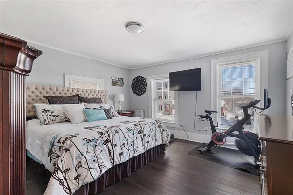 a bedroom with a bed and a flat screen tv