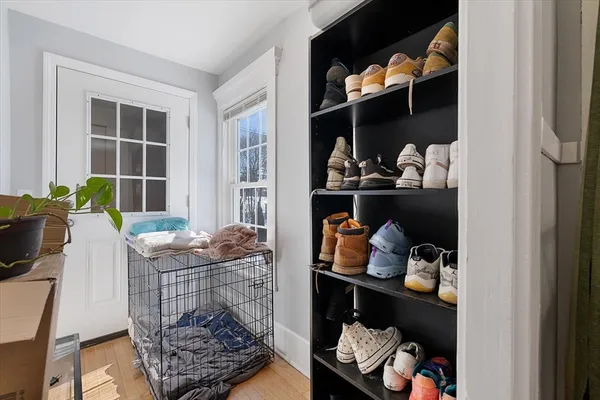 a room with a baby crib and a wooden floor