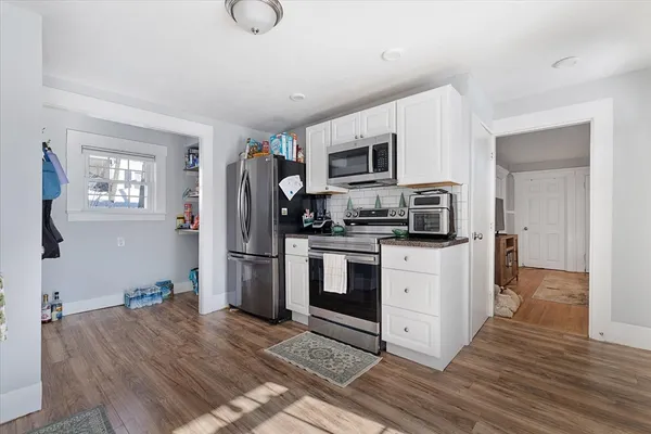 a kitchen with stainless steel appliances a refrigerator stove and microwave