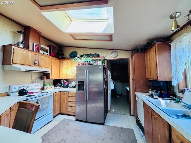 129 Evergreen Lane Florence, OR 97439 - Photo 9 of 13 a kitchen with stainless steel appliances granite countertop a refrigerator a sink dishwasher a stove and a refrigerator