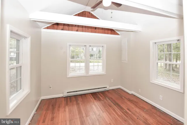 a view of a house with a yard and tree