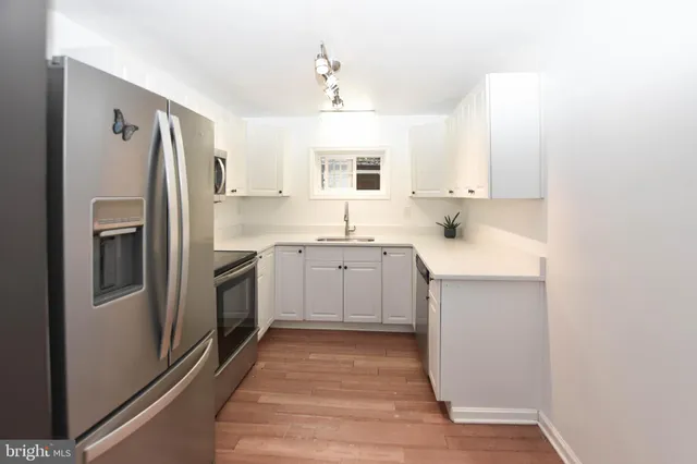 a kitchen with a sink stove and refrigerator