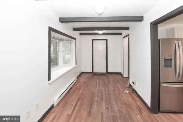 a view of a kitchen with wooden floor