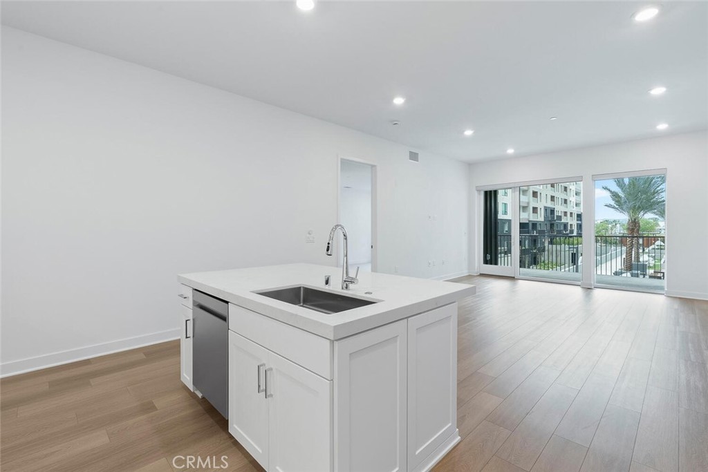 1306 Rivington Irvine, CA 92612 - Photo 12 of 75 a kitchen that has a sink and a stove
