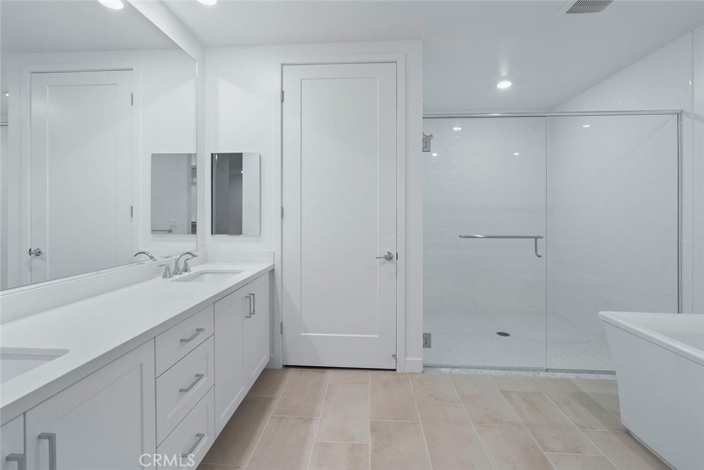 1306 Rivington Irvine, CA 92612 - Photo 19 of 75 a bathroom with a double vanity sink and a mirror