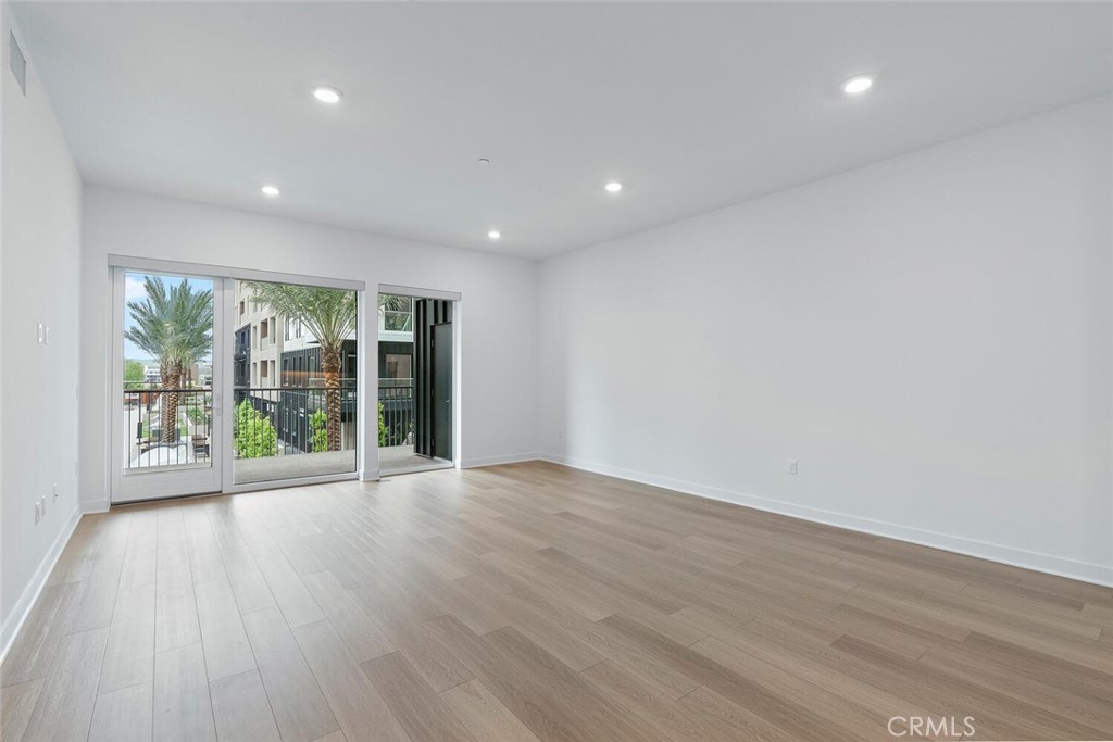 1306 Rivington Irvine, CA 92612 - Photo 2 of 75 a view of an empty room with wooden floor and glass door