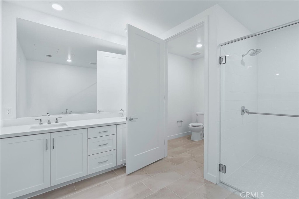 1306 Rivington Irvine, CA 92612 - Photo 21 of 75 a bathroom with a double vanity sink toilet and a shower