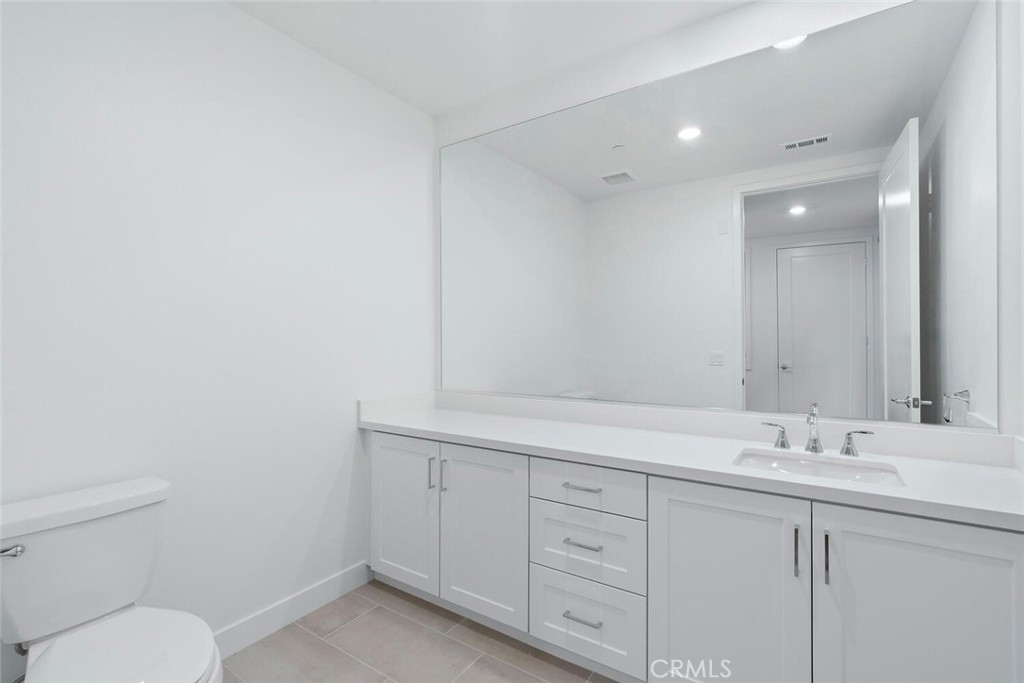 1306 Rivington Irvine, CA 92612 - Photo 24 of 75 a bathroom with a toilet sink and mirror
