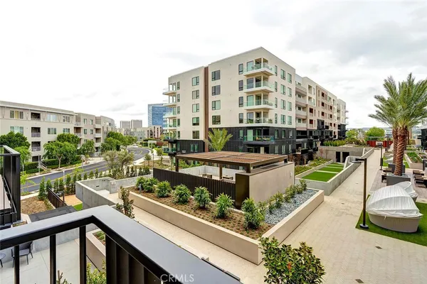 a building outdoor space with patio furniture and potted plants