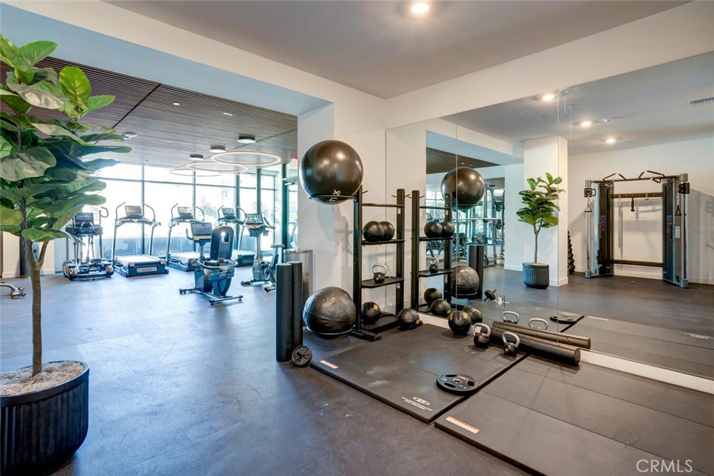 1306 Rivington Irvine, CA 92612 - Photo 38 of 75 a room with gym equipment and a large window