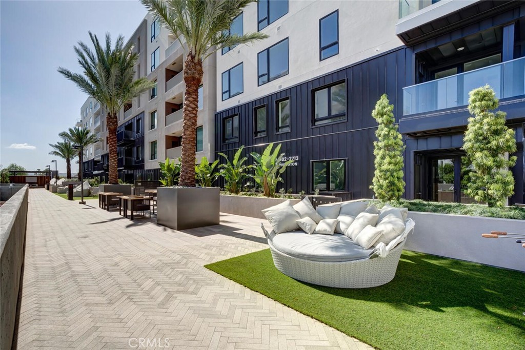 1306 Rivington Irvine, CA 92612 - Photo 40 of 75 a view of a patio with couches table and chairs potted plants and palm trees