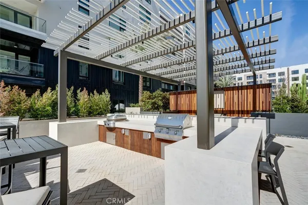 a view of swimming pool that has lawn chairs with plants and lake view
