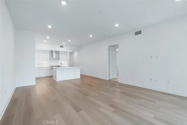 a kitchen with kitchen island a sink stainless steel appliances and cabinets
