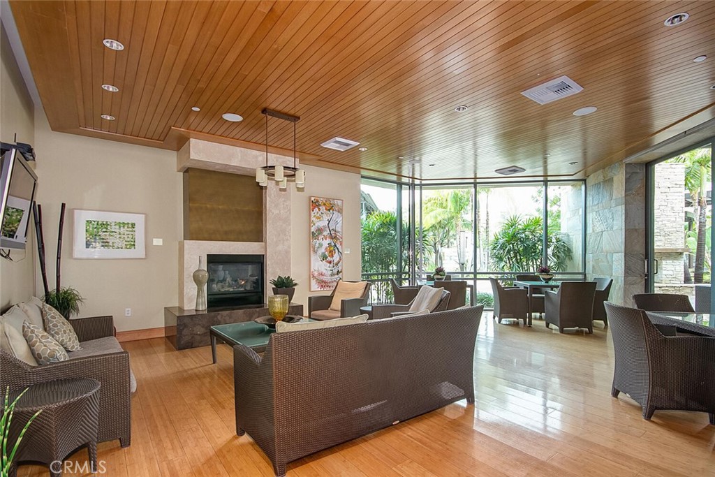 1306 Rivington Irvine, CA 92612 - Photo 69 of 75 a living room with furniture a fireplace and a floor to ceiling window