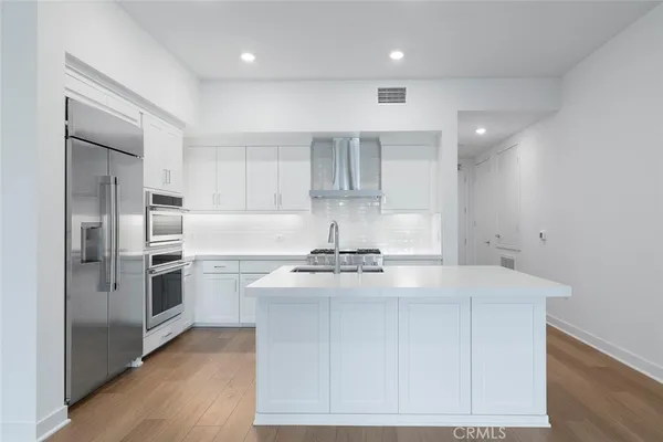 a kitchen with granite countertop a stove and a refrigerator