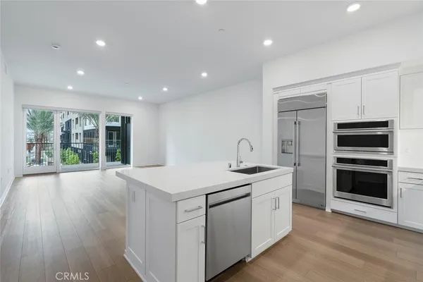 a kitchen that has a sink and a stove