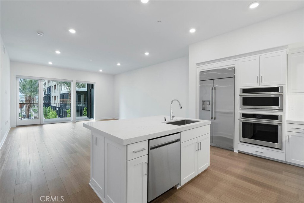 1306 Rivington Irvine, CA 92612 - Photo 9 of 75 a kitchen that has a sink and a stove in it