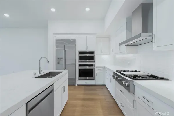 a kitchen with granite countertop white cabinets and white stove