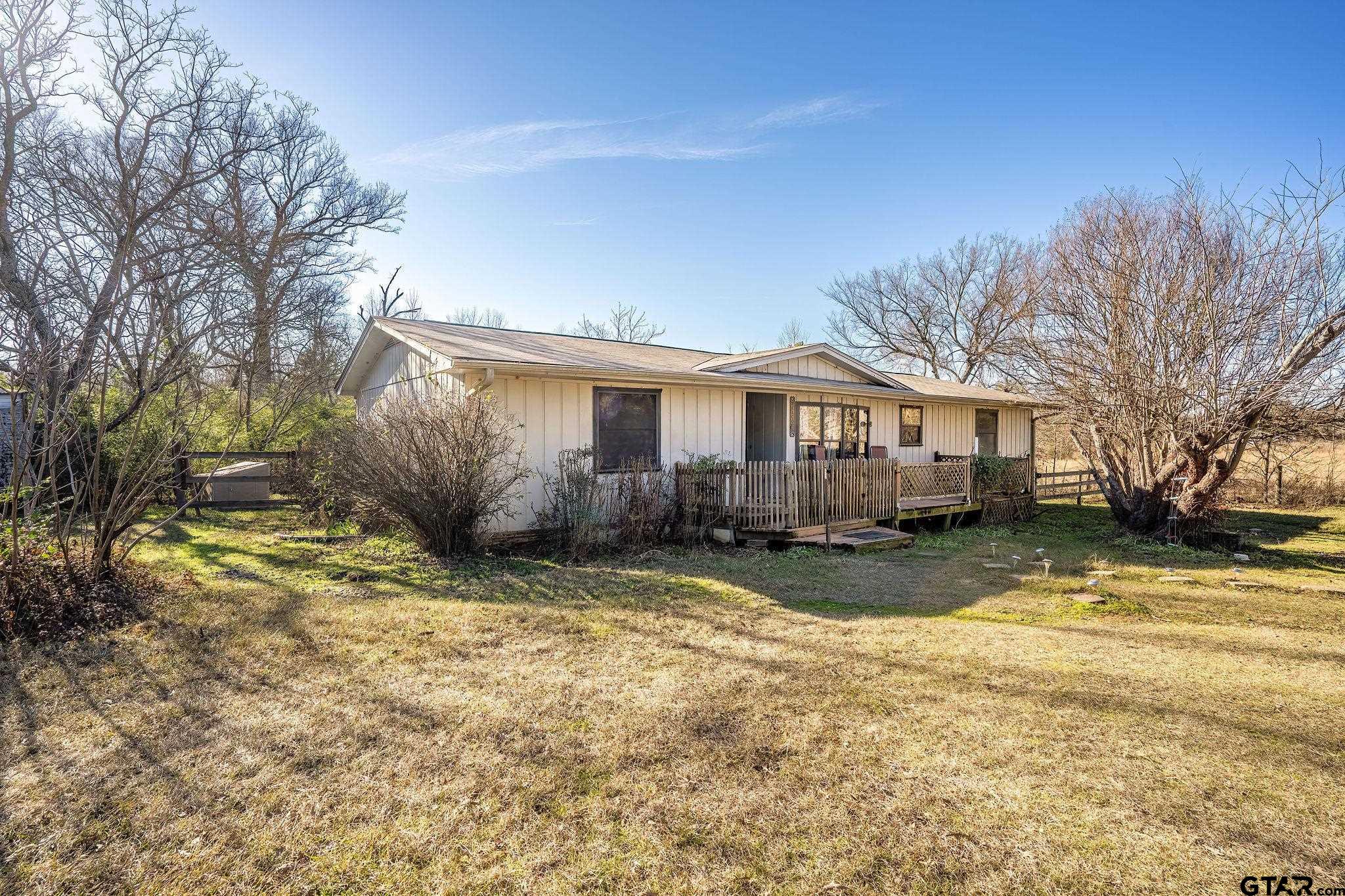 8439 Hyena Road Gilmer, TX 75644 - Photo 1 of 16 a view of a house with a yard covered in snow