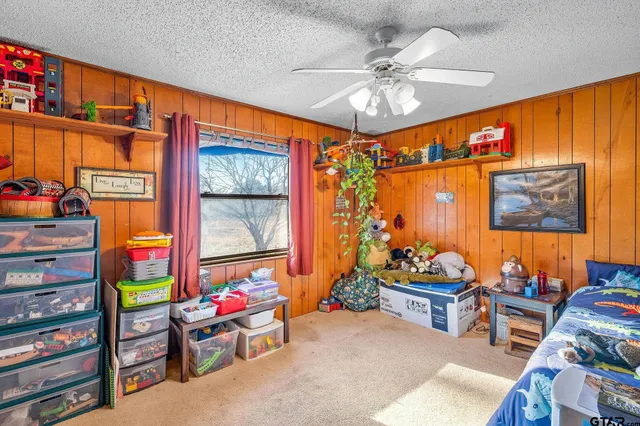 a living room with furniture a rug and a window