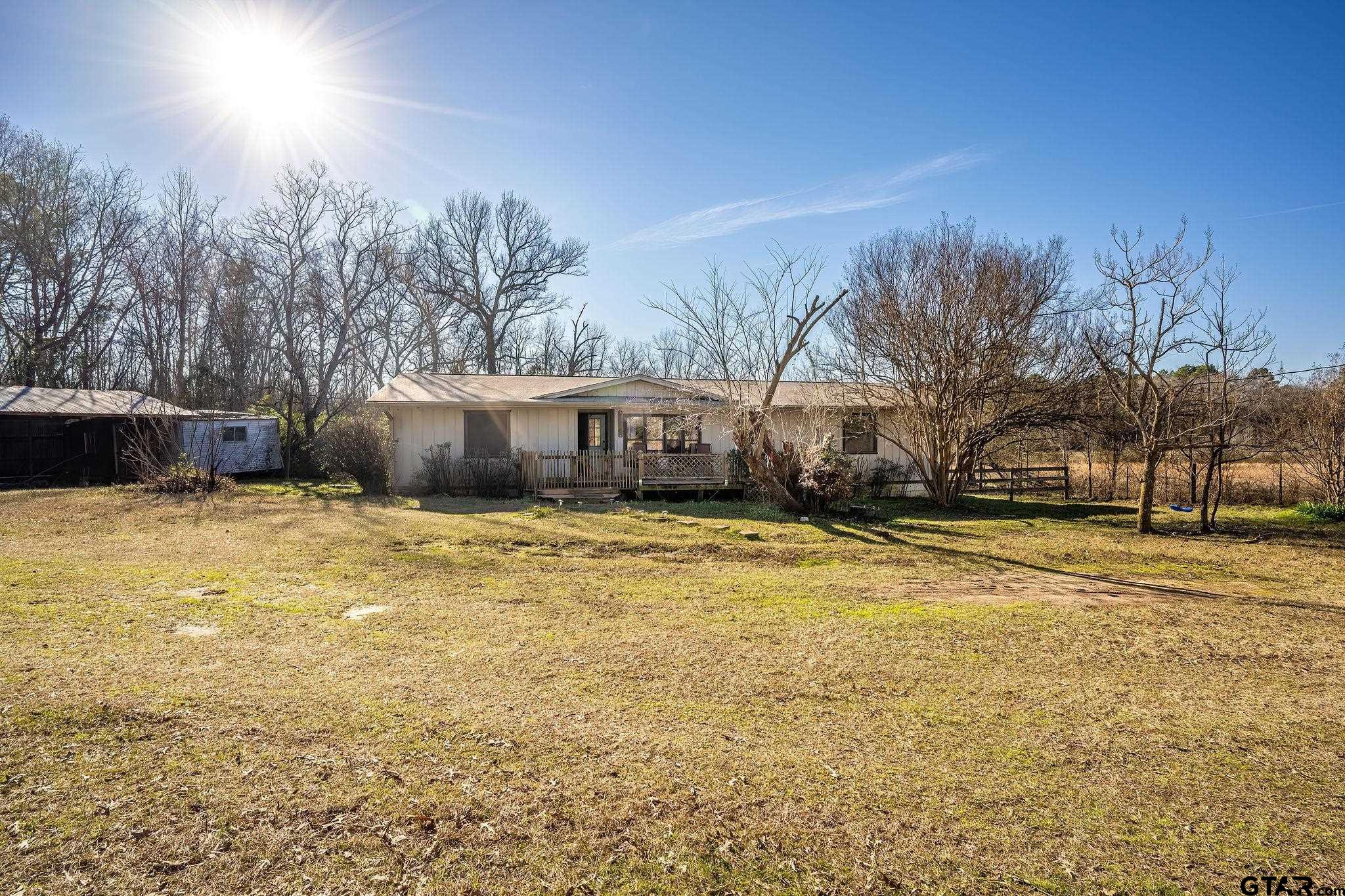 8439 Hyena Road Gilmer, TX 75644 - Photo 14 of 16 a view of a house with a yard