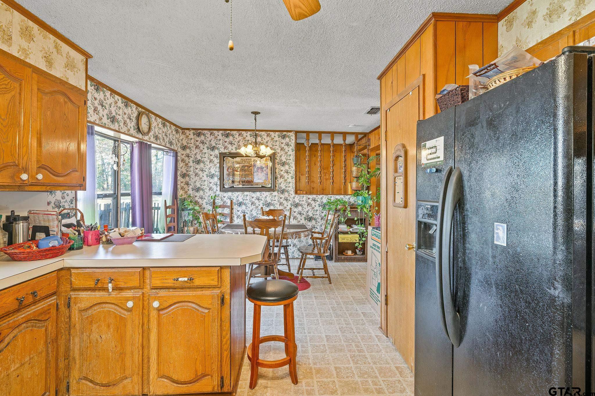 8439 Hyena Road Gilmer, TX 75644 - Photo 5 of 16 a view of a kitchen with a table and chairs