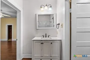 a bathroom with a sink and a mirror