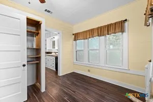 a view of wooden floor and windows in a room