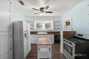 a kitchen with stainless steel appliances granite countertop a stove and a refrigerator