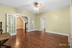 a view of empty room with wooden floor