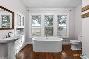 a view of a bathroom with a tub and sink