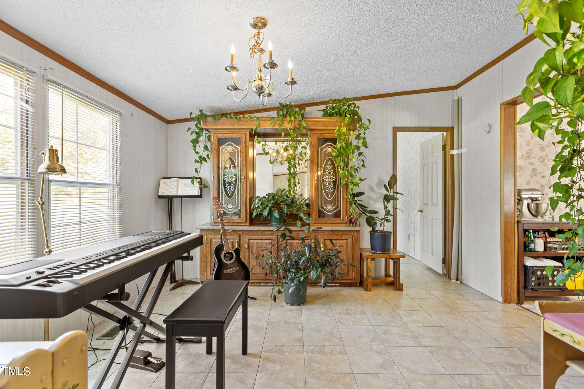 1946 Sanders Road Willow Spring, NC 27592 - Photo 21 of 59 a view of a dining room with furniture and a chandelier