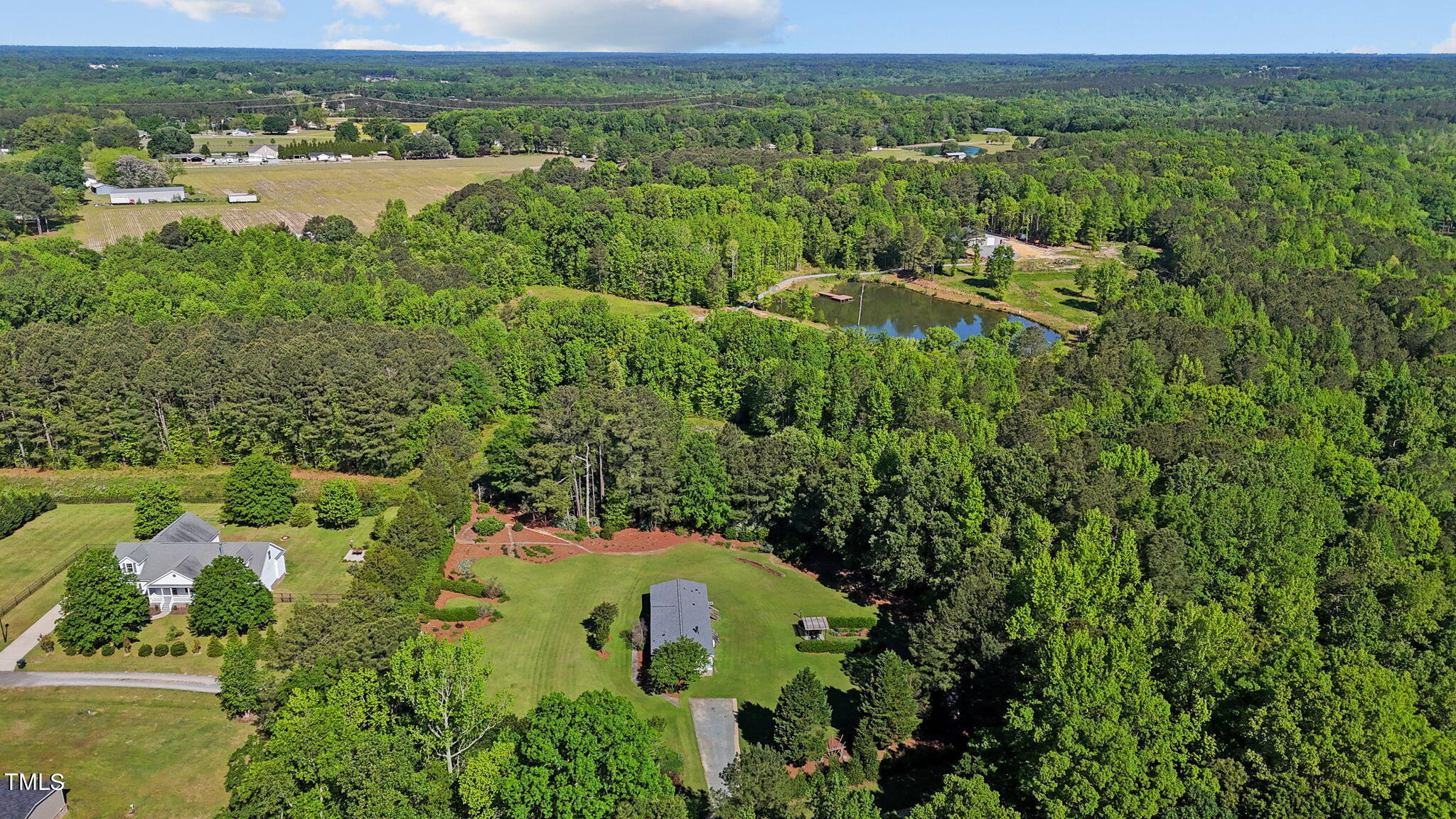 1946 Sanders Road Willow Spring, NC 27592 - Photo 54 of 59 a view of a lake with a house in the background