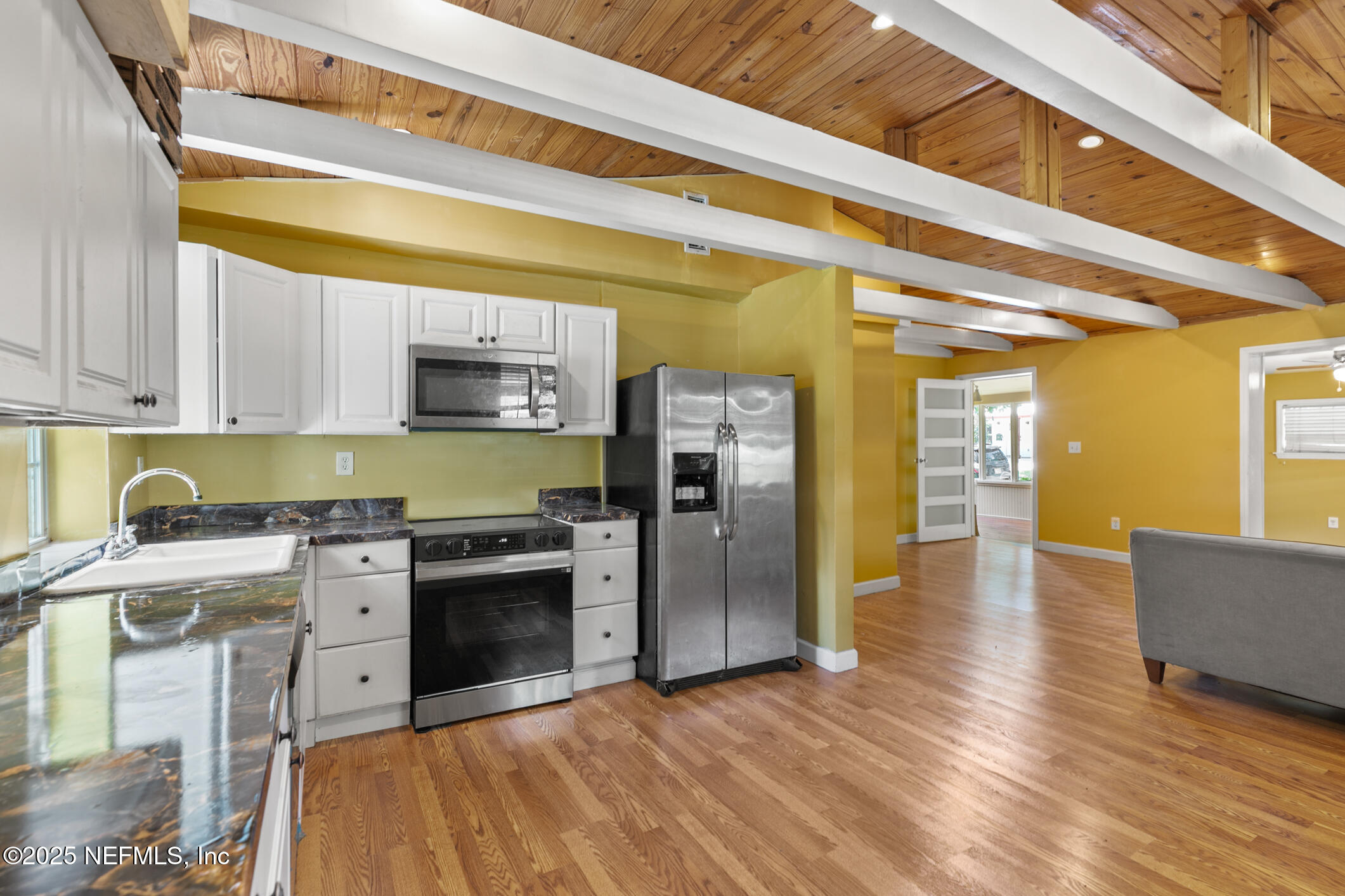 111 Palmer Street St. Augustine, FL 32084 - Photo 20 of 59 a kitchen with stainless steel appliances granite countertop a stove and a refrigerator
